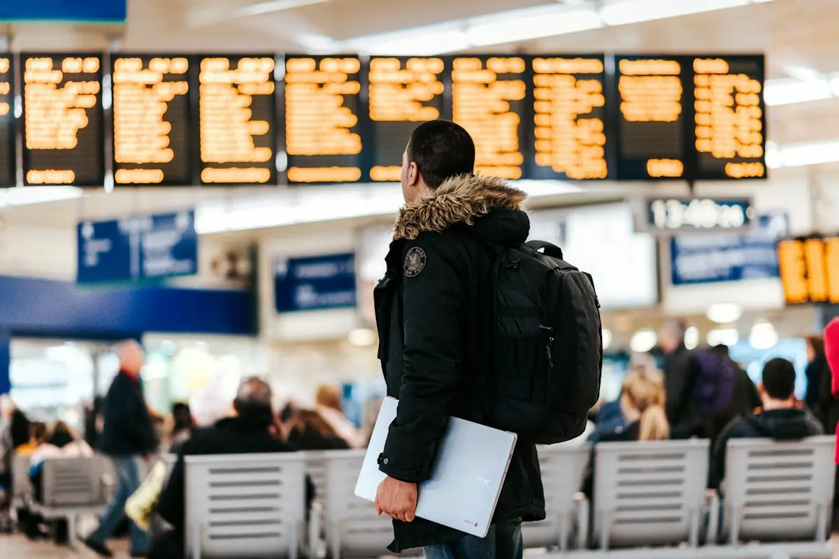 Traveller checking the departures board at an airport